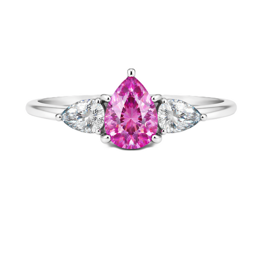 Pink sapphire ring with 7×5 mm pear center and side stones in white gold-plated 925 silver. Elegant and feminine for daily wear. Available now at BSI Jewelry.