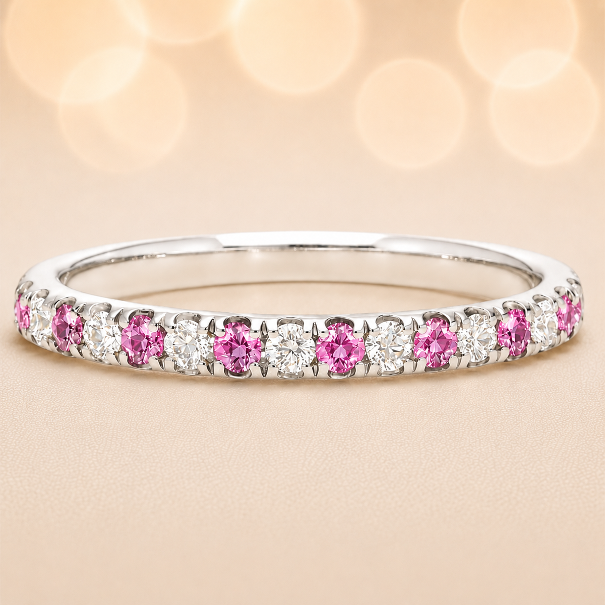 Pink sapphire wedding band with 1.80 mm round-cut stones, crafted in white gold-plated 925 silver and accented with moissanite. Available now at BSI Jewelry.