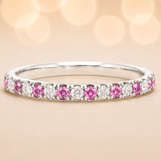 Pink sapphire wedding band with 1.80 mm round-cut stones, crafted in white gold-plated 925 silver and accented with moissanite. Available now at BSI Jewelry.