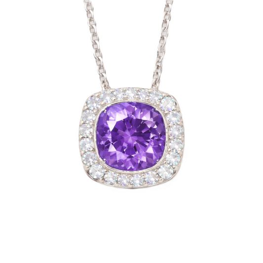 Purple sapphire cushion pendant with 6 mm center stone in white gold-plated 925 silver, accented with moissanite. Elegant and refined. Available now at BSI Jewelry.