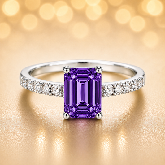 7×5mm emerald-cut Purple Sapphire ring with Moissanite accents in white-gold-plated 925 silver. Elegant, radiant, and hypoallergenic. Available at BSI Jewelry.
