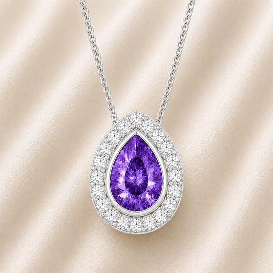 Purple sapphire halo pendant with 7×5 mm pear cut in white gold-plated 925 silver, accented with moissanite. Elegant and refined. Available now at BSI Jewelry.