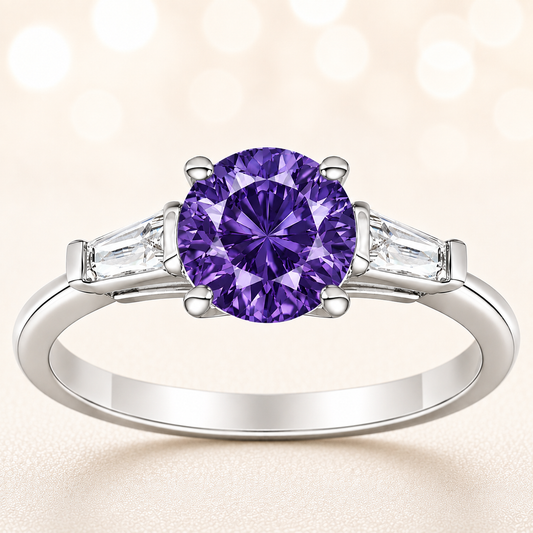 Purple sapphire ring, 6 mm round, with tapered moissanite accents in white gold-plated 925 silver. Rich and elegant. Available now at BSI Jewelry.