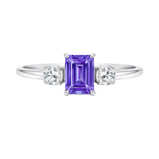 Purple sapphire ring, 6×4 mm emerald cut with 3 mm moissanite sides, set in white gold-plated 925 silver. Elegant and hypoallergenic. Available now at BSI Jewelry.
