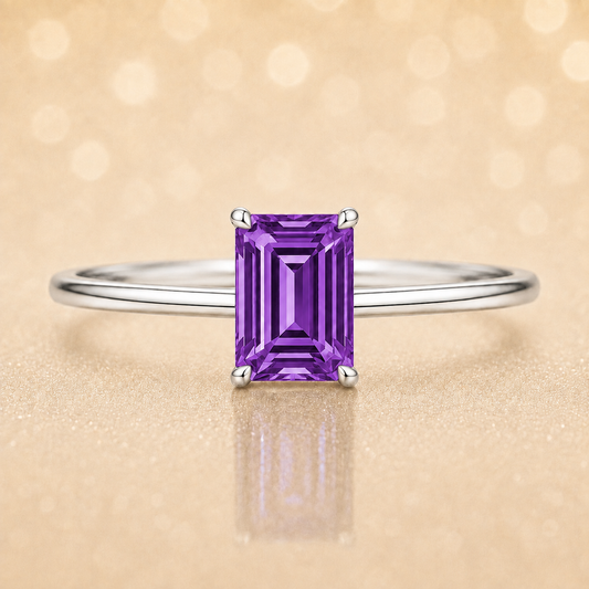 Elegant 6×4 mm emerald-cut purple sapphire ring crafted in white gold-plated 925 silver with palladium alloy. Timeless brilliance. Available now at BSI Jewelry.