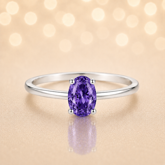 Purple sapphire solitaire ring with a 6×4 mm oval in white gold-plated 925 silver. Elegant, minimal, and timeless for daily wear. Available now at BSI Jewelry.