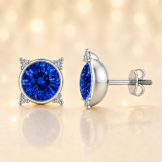 Round blue sapphire stud earrings with moissanite accents in white gold-plated 925 silver. Elegant and hypoallergenic. Available now at BSI Jewelry.