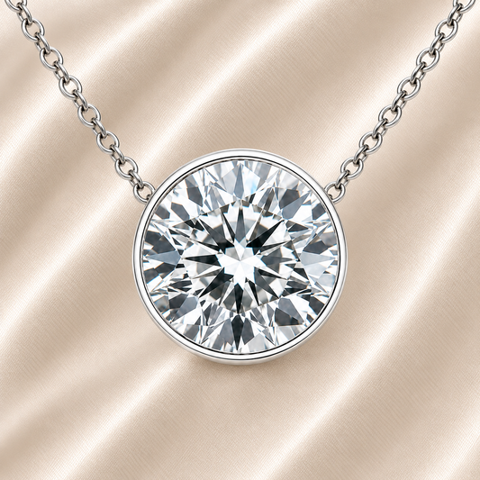 Round moissanite bezel necklace, 10 mm round, crafted in white gold-plated 925 silver. Hypoallergenic and elegant for daily wear. Available now at BSI Jewelry.