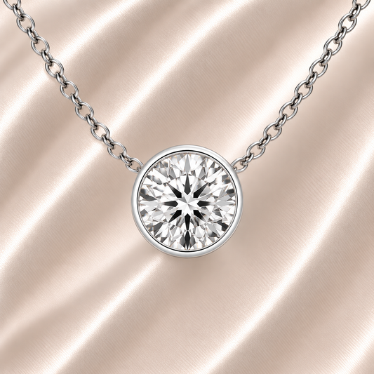 Round moissanite bezel necklace, 7 mm round, crafted in white gold-plated 925 silver. Hypoallergenic and elegant for daily wear. Available now at BSI Jewelry.