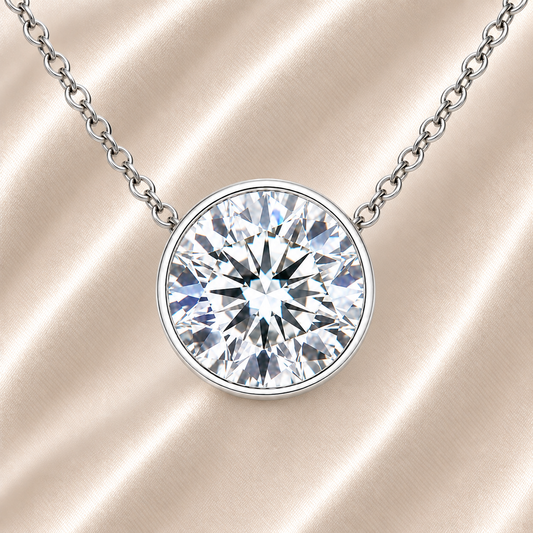 Round moissanite bezel necklace, 9 mm round, crafted in white gold-plated 925 silver. Hypoallergenic and elegant for daily wear. Available now at BSI Jewelry.
