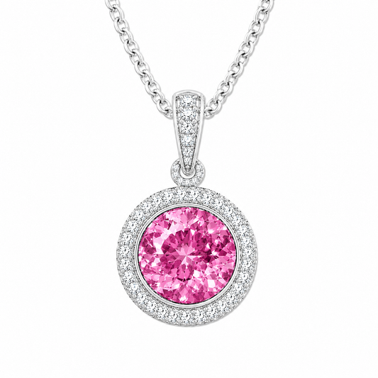 Round pink sapphire pendant, 6 mm round, crafted in white gold-plated 925 silver with moissanite halo accents. Available now at BSI Jewelry.