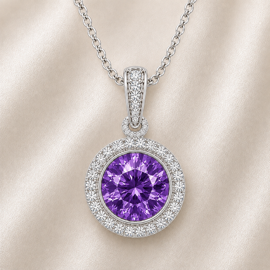 Round purple sapphire pendant crafted in white gold-plated 925 silver with moissanite halo accents. Available now at BSI Jewelry.