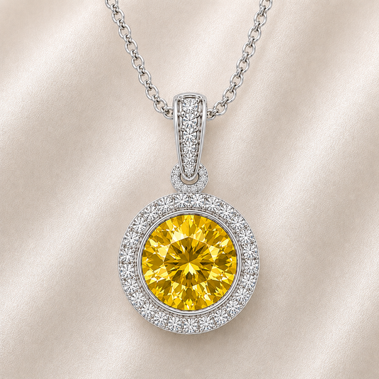 Round yellow sapphire pendant, 6 mm round, crafted in white gold-plated 925 silver with moissanite halo accents. Available now at BSI Jewelry.
