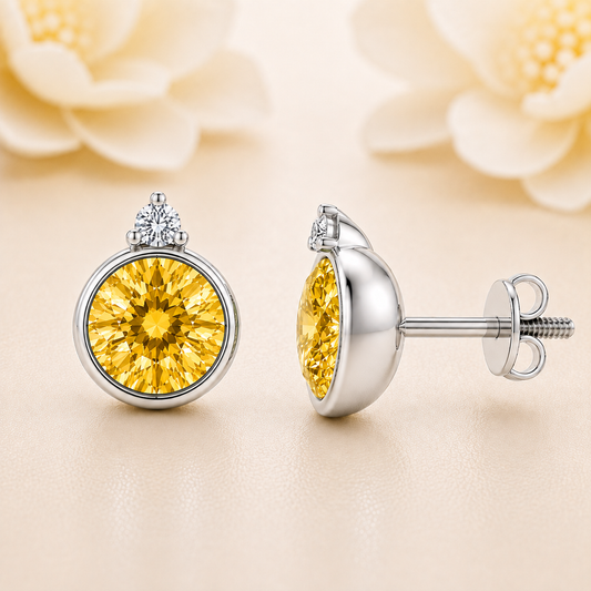Yellow sapphire stud earrings, 5 mm round, crafted in white gold-plated 925 silver. Bright and hypoallergenic. Available now at BSI Jewelry.
