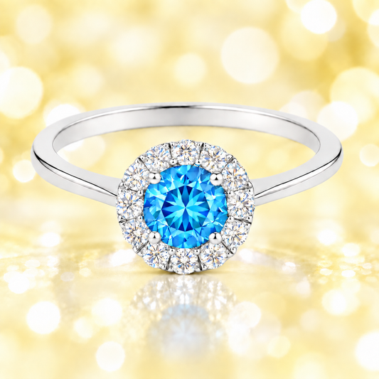 Sky blue topaz ring with a 4.50 mm round-cut in white gold-plated 925 silver, accented with moissanite for fresh blue brilliance. Available now at BSI Jewelry.