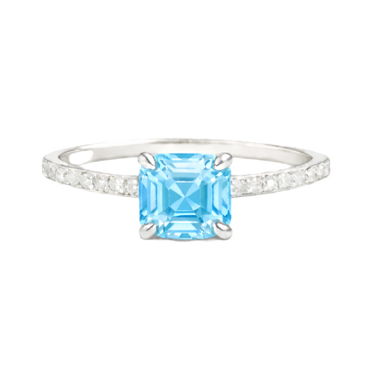 Sky blue topaz ring with a 6 mm Asscher-cut in white gold-plated 925 silver, accented with moissanite and fresh blue brilliance. Available now at BSI Jewelry.