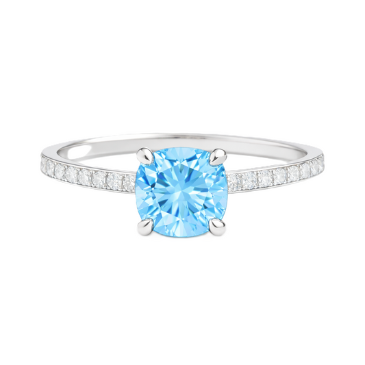 Sky blue topaz ring with a 6 mm cushion in white gold-plated 925 silver, accented with moissanite. Fresh and elegant for daily wear. Available now at BSI Jewelry.