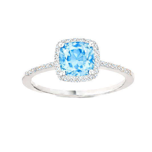 Sky blue topaz ring with a 6 mm cushion-cut center in white gold-plated 925 silver, accented with moissanite. Available now at BSI Jewelry.