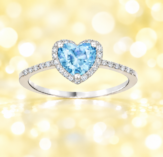 Sky blue topaz ring with a 6 mm heart cut, crafted in white gold-plated 925 silver and accented with moissanite. Available now at BSI Jewelry.