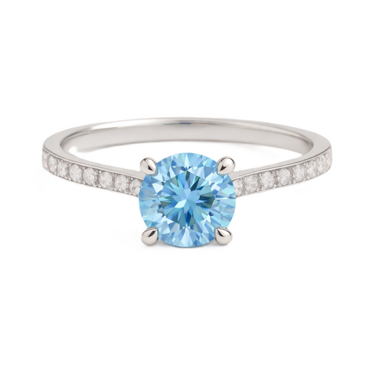 Sky blue topaz ring with a 6 mm round-cut and moissanite accents, crafted in white gold-plated 925 silver. Elegant for daily wear. Available now at BSI Jewelry.