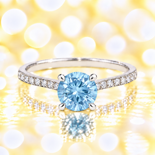 Sky blue topaz ring with a 6 mm round-cut and moissanite accents, crafted in white gold-plated 925 silver. Elegant for daily wear. Available now at BSI Jewelry.