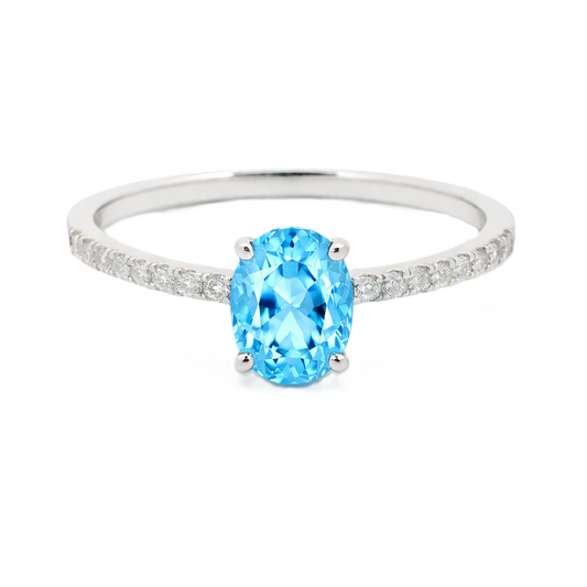Sky blue topaz ring with a 7×5 mm oval-cut stone and moissanite accents in white gold plated 925 silver. Elegant for daily wear. Available now at BSI Jewelry.