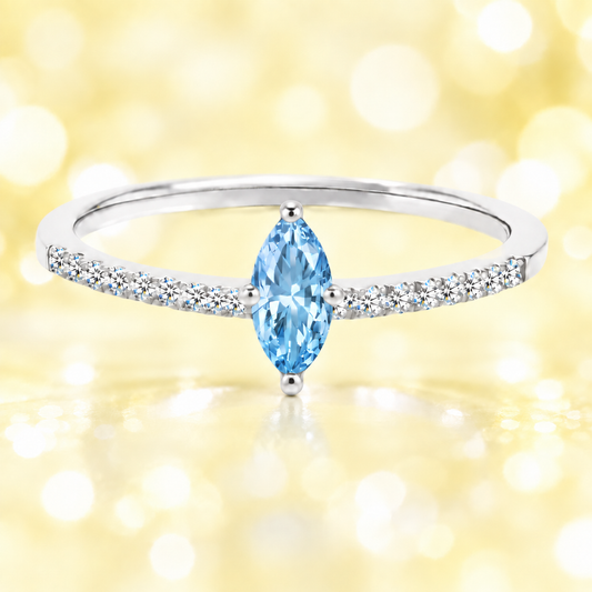 Sky blue topaz ring with an 8×4 mm marquise-cut stone, accented by moissanite in white gold-plated 925 silver. Fresh and elegant. Available now at BSI Jewelry.