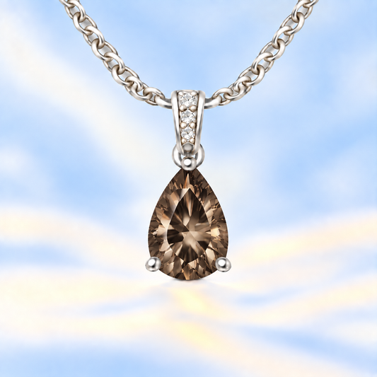 Smoky quartz pendant with an 8×5 mm pear cut, crafted in white gold-plated 925 silver. Warm and elegant for daily wear. Available now at BSI Jewelry.