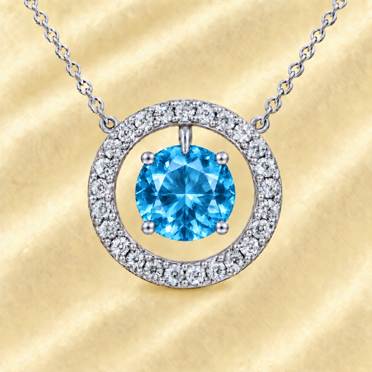 Swiss blue topaz necklace with a 6 mm round gemstone and moissanite halo in white gold-plated 925 silver. Elegant and radiant. Available now at BSI Jewelry.