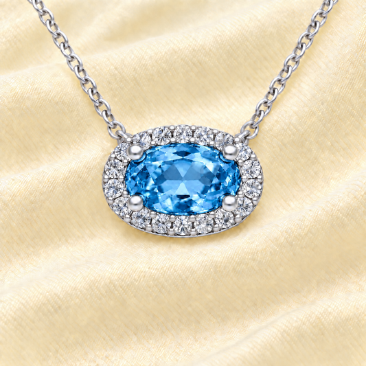 Swiss blue topaz necklace with a 7×4 mm oval in white gold-plated 925 silver, with moissanite. Elegant and refined for daily wear. Available now at BSI Jewelry.