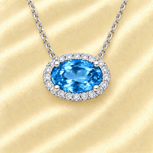 Swiss blue topaz necklace with 8×5 mm oval gemstone in white gold-plated 925 silver, accented with moissanite. Fresh and elegant. Available now at BSI Jewelry.