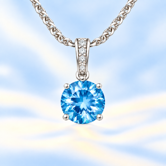 Swiss blue topaz pendant with a 6 mm round cut, set in white gold-plated 925 silver. Bright, fresh, and elegant for daily wear. Available now at BSI Jewelry.