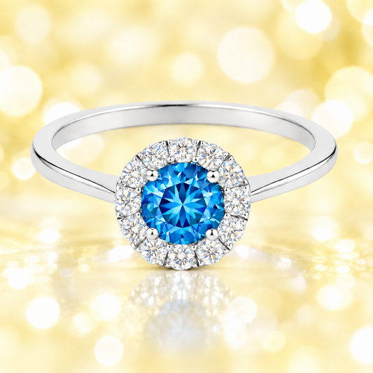 Swiss blue topaz ring with a 4.50 mm round-cut in white gold-plated 925 silver, accented with moissanite for vivid blue brilliance. Available now at BSI Jewelry.