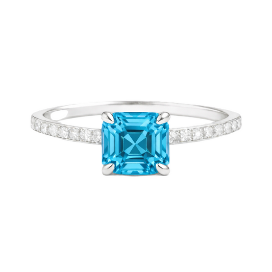 Swiss blue topaz ring with a 6 mm Asscher-cut in white gold-plated 925 silver, accented with moissanite and vivid blue brilliance. Available now at BSI Jewelry.