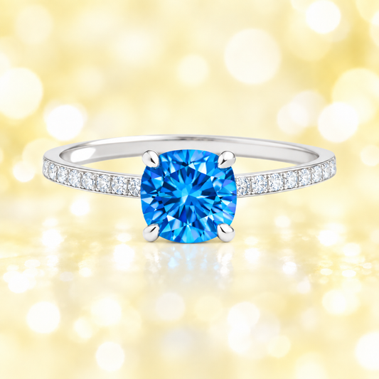 Swiss blue topaz ring with a 6 mm cushion in white gold-plated 925 silver, accented with moissanite. Fresh and elegant for daily wear. Available now at BSI Jewelry.