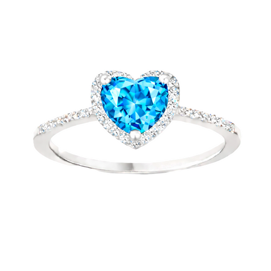 Swiss blue topaz ring with a 6 mm heart cut, crafted in white gold-plated 925 silver and accented with moissanite. Available now at BSI Jewelry.