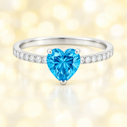 Swiss blue topaz ring with a 6 mm heart in white gold-plated 925 silver, with moissanite. Romantic and elegant for daily wear. Available now at BSI Jewelry.
