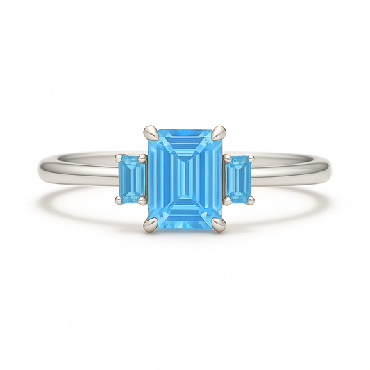 Striking Swiss blue topaz ring with 6×4 mm and 4×2 mm emerald-cut stones in white gold-plated 925 silver with palladium alloy. Radiant joy. Now at BSI Jewelry.