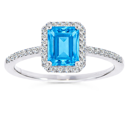 Swiss blue topaz ring with a 7×5 mm emerald cut, with moissanite in white gold-plated 925 silver. Elegant and timeless for daily wear. Available now at BSI Jewelry.