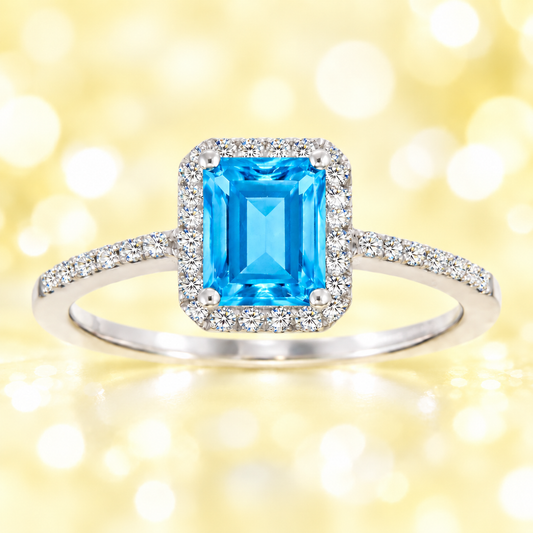 Swiss blue topaz ring with a 7×5 mm emerald cut, with moissanite in white gold-plated 925 silver. Elegant and timeless for daily wear. Available now at BSI Jewelry.