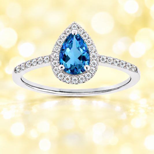 Swiss blue topaz ring with a 7×5 mm pear cut, with moissanite in white gold-plated 925 silver. Elegant and timeless for daily wear. Available now at BSI Jewelry.
