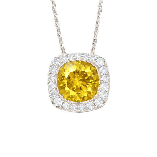 Yellow sapphire cushion pendant with 6 mm center stone in white gold-plated 925 silver, accented with moissanite. Elegant and radiant. Available at BSI Jewelry.