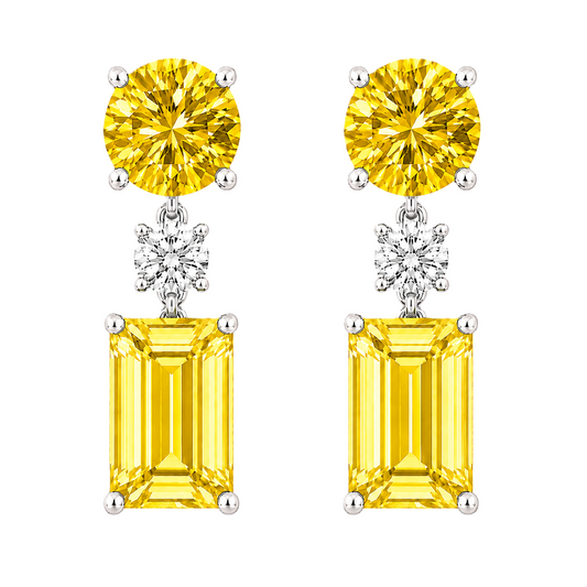 Yellow sapphire drop earrings with 5mm round and 6×4mm emerald cut, crafted in white gold-plated 925 silver with palladium-added alloy. Available at BSI Jewelry