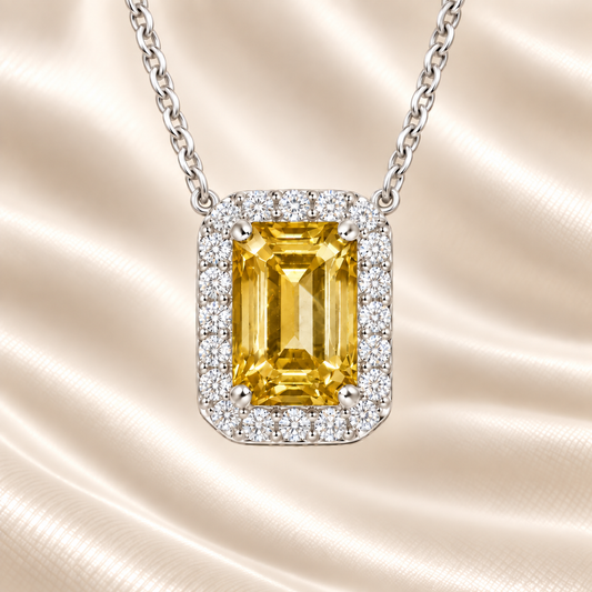 Yellow sapphire emerald cut necklace with 7×5 mm center stone in white gold-plated 925 silver. Radiant and elegant for everyday wear. Available now at BSI Jewelry.