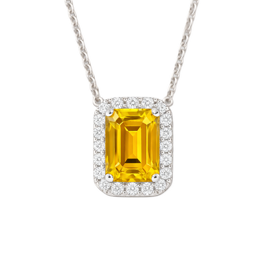 Yellow sapphire emerald cut pendant with 7×5 mm center stone in white gold-plated 925 silver. Radiant and elegant for everyday wear. Available now at BSI Jewelry.