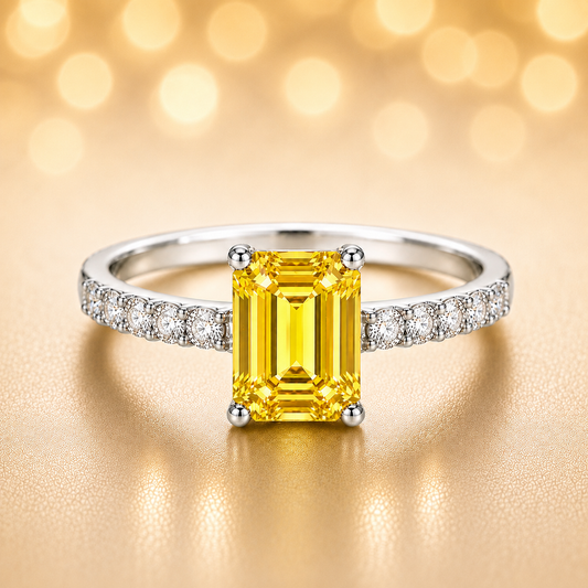 7×5mm emerald-cut Yellow Sapphire engagement ring with Moissanite accents in white-gold-plated 925 silver. Elegant and hypoallergenic. Available at BSI Jewelry.