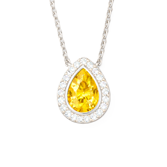 Yellow sapphire halo pendant with a 7×5 mm pear cut in white gold-plated 925 silver, accented with moissanite. Elegant and radiant. Available now at BSI Jewelry.