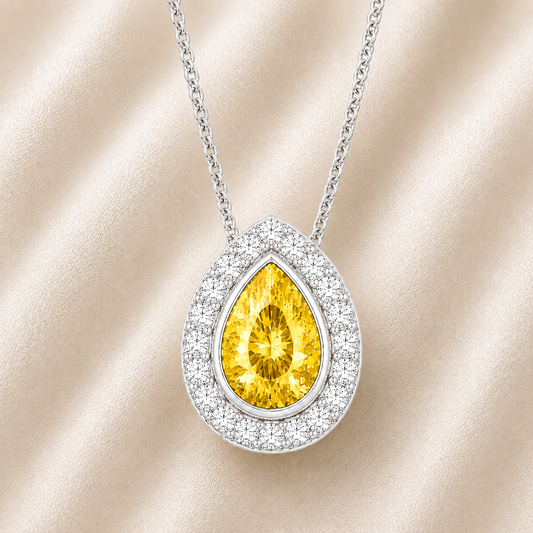 Yellow sapphire halo pendant with a 7×5 mm pear cut in white gold-plated 925 silver, accented with moissanite. Elegant and radiant. Available now at BSI Jewelry.