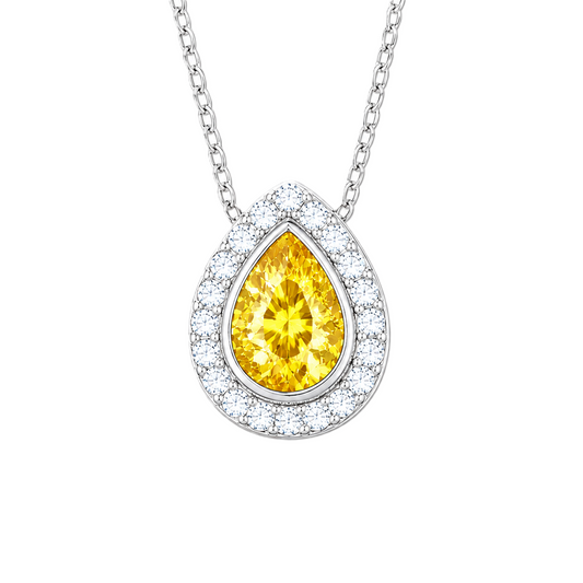 Yellow sapphire halo pendant with a 7×5 mm pear cut in white gold-plated 925 silver, accented with moissanite. Elegant and radiant. Available now at BSI Jewelry.