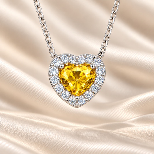 Yellow sapphire heart necklace with 6 mm center stone in white gold-plated 925 silver. Radiant and elegant for everyday wear. Available now at BSI Jewelry.